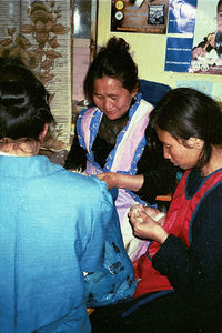 Kindergarden childrens mothers is being taught sewing and weaving to enable them to make a livi