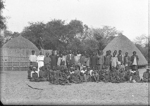 Group of African people in front of huts, Ricatla, Mozambique, ca. 1896-1911