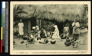 Missionary sister tends to a sick woman, Togo, ca. 1920-1940