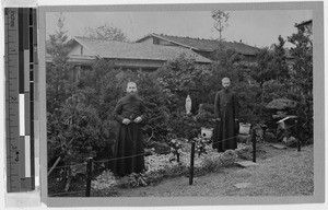 Fathers Monge and Reynaud standing in a garden, Hakodate, Japan, ca. 1909