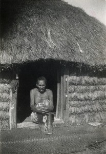 An old leper in front of his hut