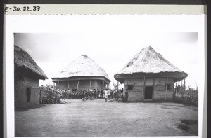 Catechist and pupils stand in front of a chapel in the Grassfields in French Cameroon