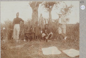Missionary Schachschneider(?) with 3 African men and 1 child, ca.1901-1914