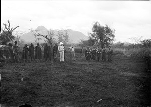 Africans with two European missionaries, Tanzania, ca.1893-1920