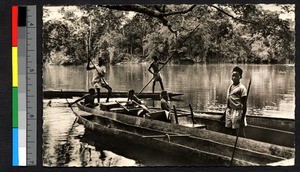 Men poling canoes on a river, Central African Republic, ca.1920-1940