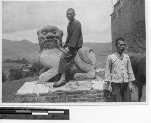 A Christian man on a statue at Luoding, China, 1934