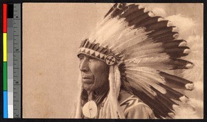 Man wearing elaborate feathered headdress, Canada, ca.1920-1940