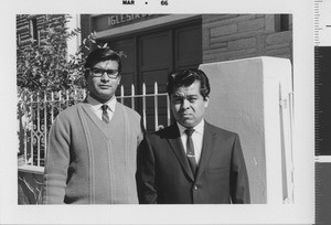 Two men in front of church of Christ building