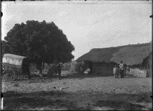 Cart and building with a thatched roof, Matutwini, Mozambique, ca. 1902-1907