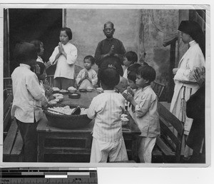 Prayers before the meal at Yangjiang, China, 1938