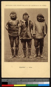 Three Inuit men stand on a patch of bare earth, Canada, ca.1920-1940