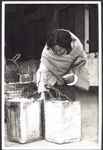 Chinese woman searching for food in the dustbins