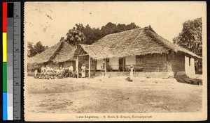 Students gathered outside of a thatch-roofed school building, Coolasagaram, India, ca.1920-1940