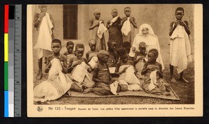 Missionary sister teaching female children to sew, Burkina Faso, ca.1920-1940