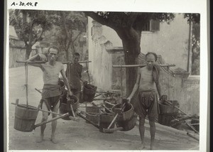 Men watering the street in China