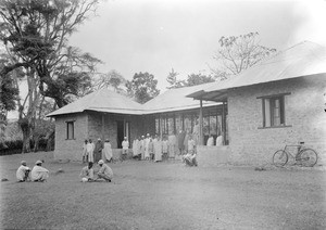 African men in front of a building, Tanzania, ca.1893-1920