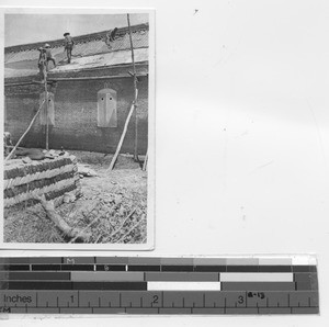 Repairing a roof at Xinbin, China, 1935