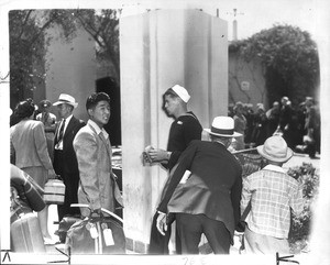 "Dramatic Meeting--As 36 more Japanese returned to the Southland yesterday, they passed many service men on their way to battle zones. Here a sailor stares at a young evacuee."--caption on photograph