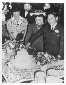 "Happy couple, Toya and Pete Matayoshi, 'Just Married' are shown cutting the wedding cake at Santa Anita Assembly Center."--caption on photograph