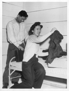 "First of San Francisco's Japanese to reach Tanforan was Mrs. Ichiro Iizuika--Here she is shown with husband unpacking in their quarters."--caption on photograph