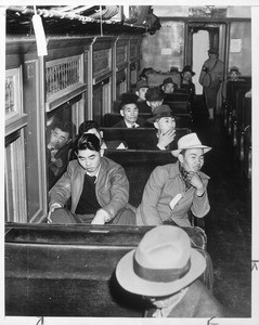 "Happy, for the most part, were Japs who formed vanguard of evacuees. Here are some of the 500 on train."--caption on photograph