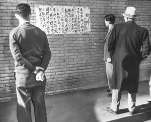 "Japanese in Little Tokyo are shown watching bulletins as the war started"--caption on photograph