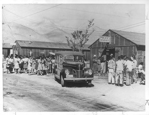 "Freed--Japanese who have been released from the Manzanar Relocation Center bid good-by to their friends there and are about to enter a station wagon that will take them to Reno, Nev., from where, unwatched, they will go east."--caption on photograph