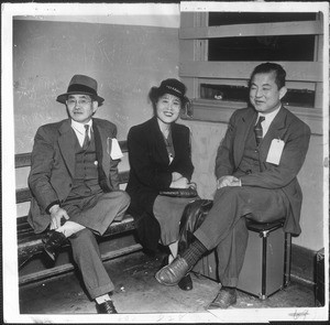 "Arrested yesterday during the sweeping Southland raids, these three smiling Japanese are shown in custody. They are, left to right, Frisco Tokichi Hasegawa, retired dry goods man; Mrs. Iku Onodesa and Tadasu Iida, teachers."--caption on photograph