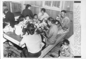 "Evacuated Japs Dine As Family Unit--Japanese family life is preserved even at mealtime in the large mess halls of this government relocation project"--caption on photograph