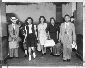 "Family Arrives--Grinning happily after they arrived at Union Station yesterday"--caption on photograph