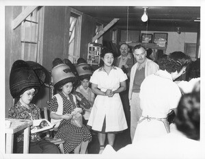 "Hair cuts are only $.20 each at this, one of several such beauty salons within the center. Photo shows a small section of one of the large, modern, well-equipped salons."--caption on photograph