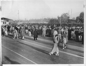 "Returning to the baggage checking station, the evacuees are segregated in seats numbered to correspond with the numbers of the cars on the train"--caption on photograph