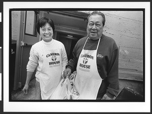 Two people of Chinese origin, Volunteers for food distribution program, Cameron House, Chinatown. San Francisco, California, 2002