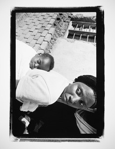 Woman with a sleeping baby on her back, Rwanda, 2004