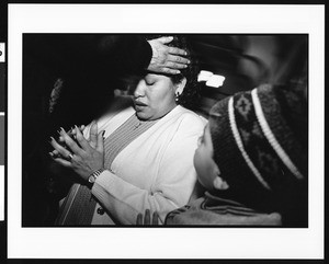 Woman in prayer during mass at Saint Thomas Church (Los Angeles, Calif.), 1996