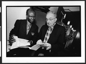 An African American & white parisioner talk together before church service, Zion Lutheran Church, Takoma Park, Maryland