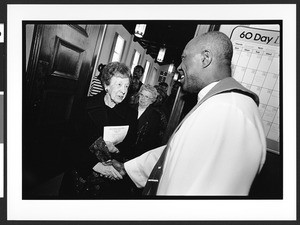 Reverend Julius Coker greets parishioners after church service, Zion Lutheran Church, Takoma Park, Maryland