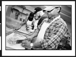 Muslim men and women preparing food for First Congregational Church homeless women's dinner program, 945 G street, NW, Washington, DC, 2002