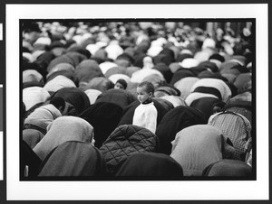 Hundreds of Muslim men during prayers, with one child standing, at EID celebration, D.C. Convention Center, Washington, DC