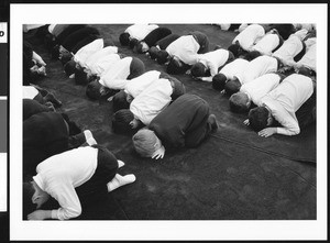 Group of boys bowing in prayer, Los Angeles, 1999