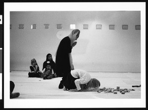 Women praying before offering of money, Los Angeles, 1999
