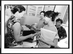 Four women of Chinese origin greeting each other in the entrance way to the Ling Shen Ching Tze Temple, Chicago, Illinois, 2002