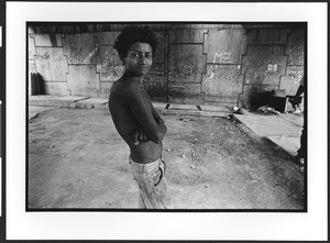 Young homeless boy standing under a highway overpass, El Salvador, 2003