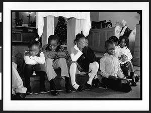 Seven African American children sitting on the steps leading to the alter, Zion Lutheran Church, Takoma Park, Maryland, 2002