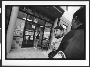 Exterior of Ed de la Cruz building with child of Filipino origin, SOMA, San Francisco, California, 2002