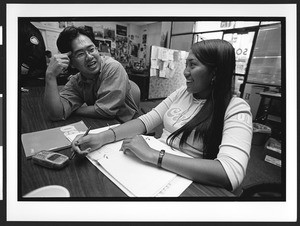 Interior of Ed de la Cruz Building with studying student and mentor, SOMA, San Francisco, California, 2002