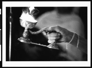 Hand holding fire in chalice, Los Angeles, 1999