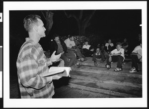 Man preaching to a group of young boys at night, Los Angeles, 1999