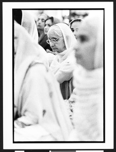 Close up of elderly Sikh woman with head scarf at prayer service of National Sikh Foundation at Travilah Elementary School, North Potomac, Maryland, 2002