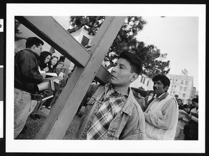 Two men carrying large cross in procession, Los Angeles, 1999